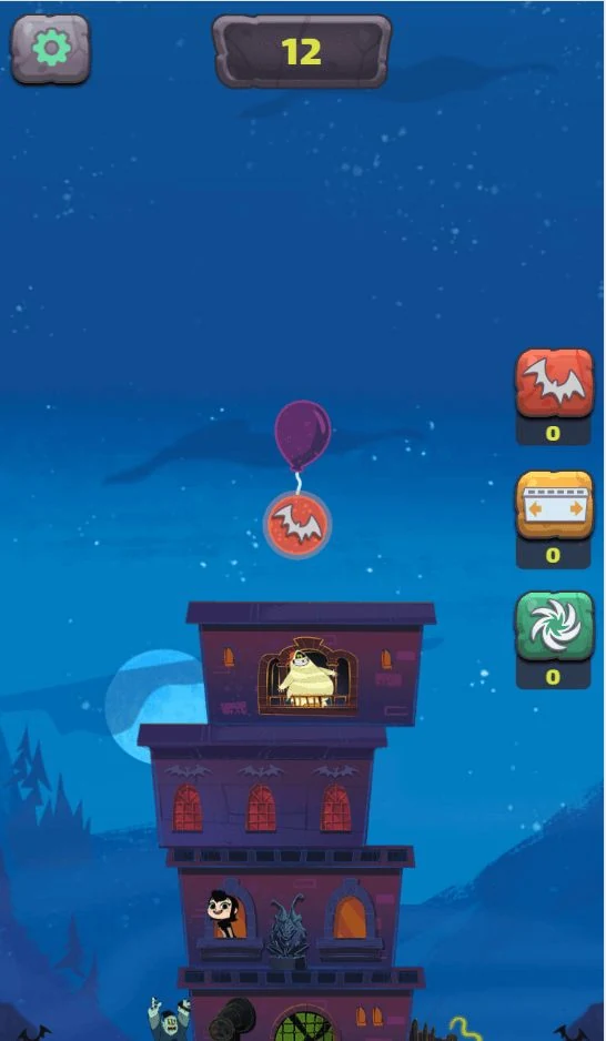 A tower of hotel storeys built up against a night sky, a balloon lowering the next storey into place, a score of 12 and three power-up slots down the right