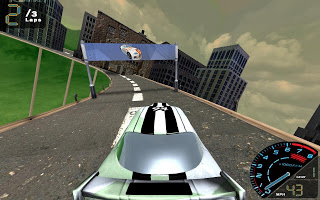 In game: a green and white racing car seen from behind on a city street, a banner strung across the track ahead and tower blocks along both sides, with two of three laps in one corner and a speedometer in the other